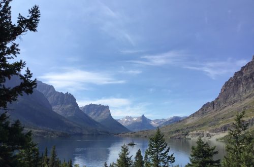 Lake with mountain reflections and a small island.