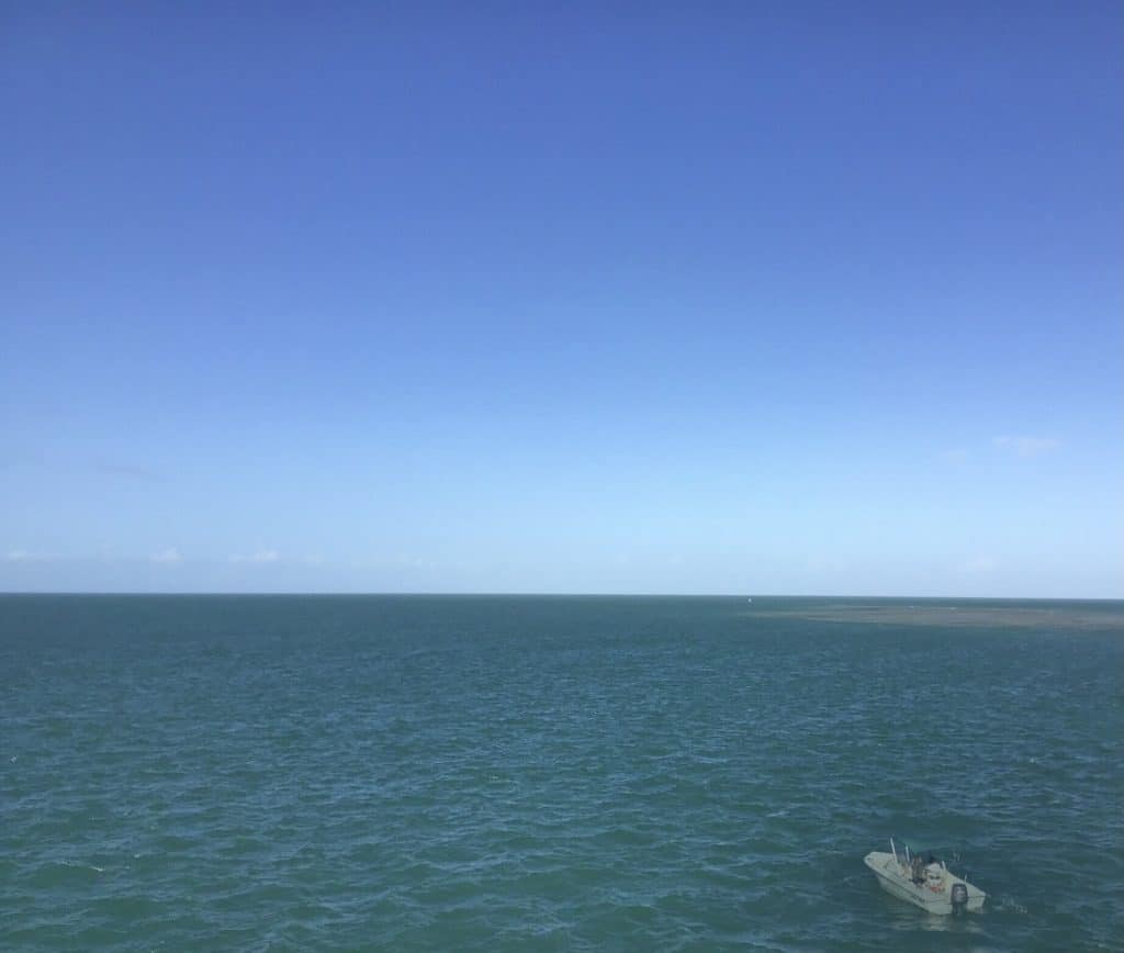 Blue-green ocean with a boat.
