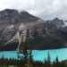 glacial lake with mountains and clouds.